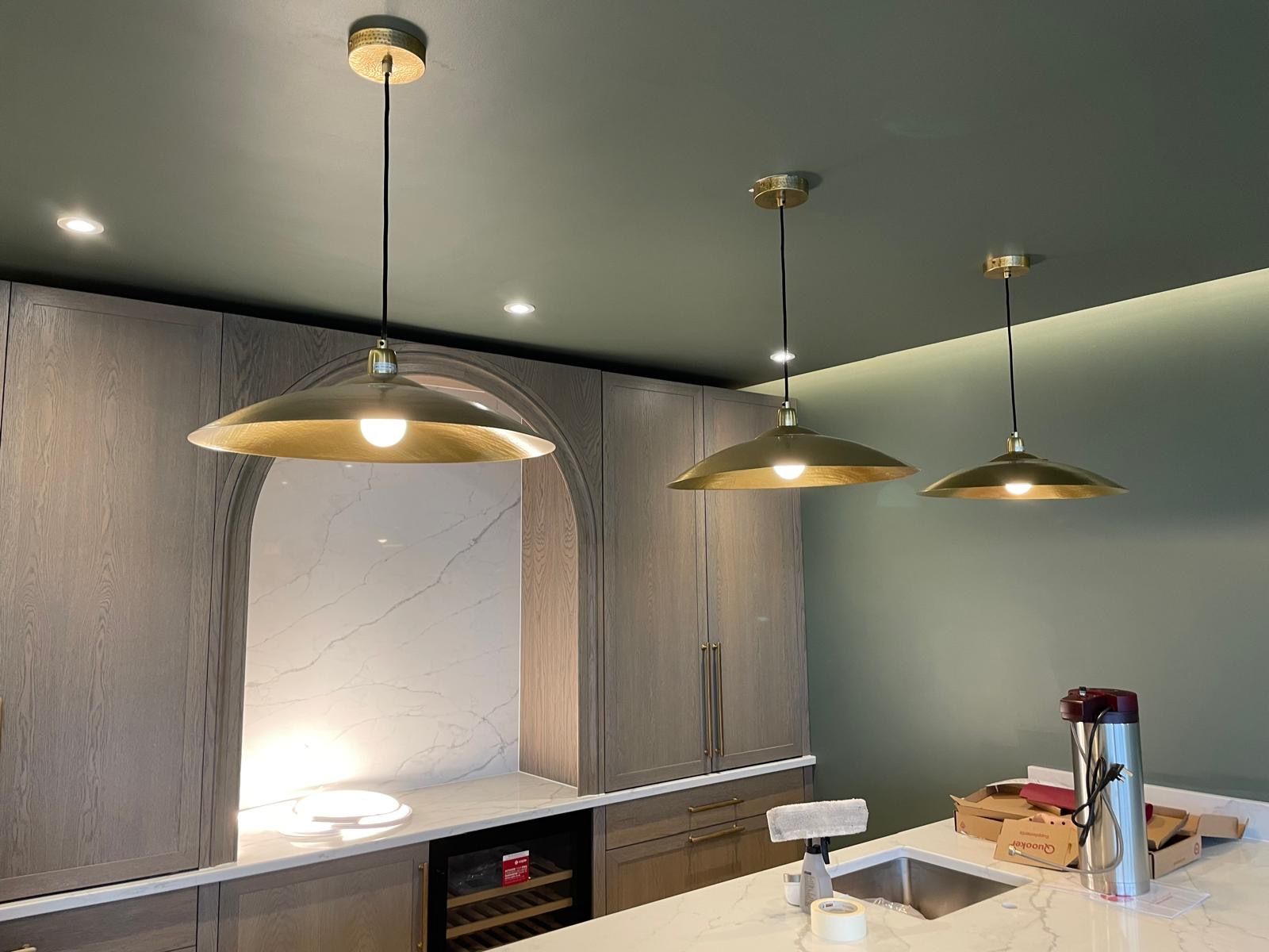 Brass pendant lights over a kitchen island